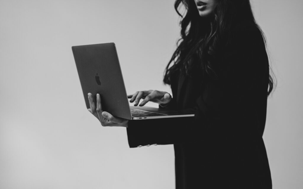 a woman holding a laptop